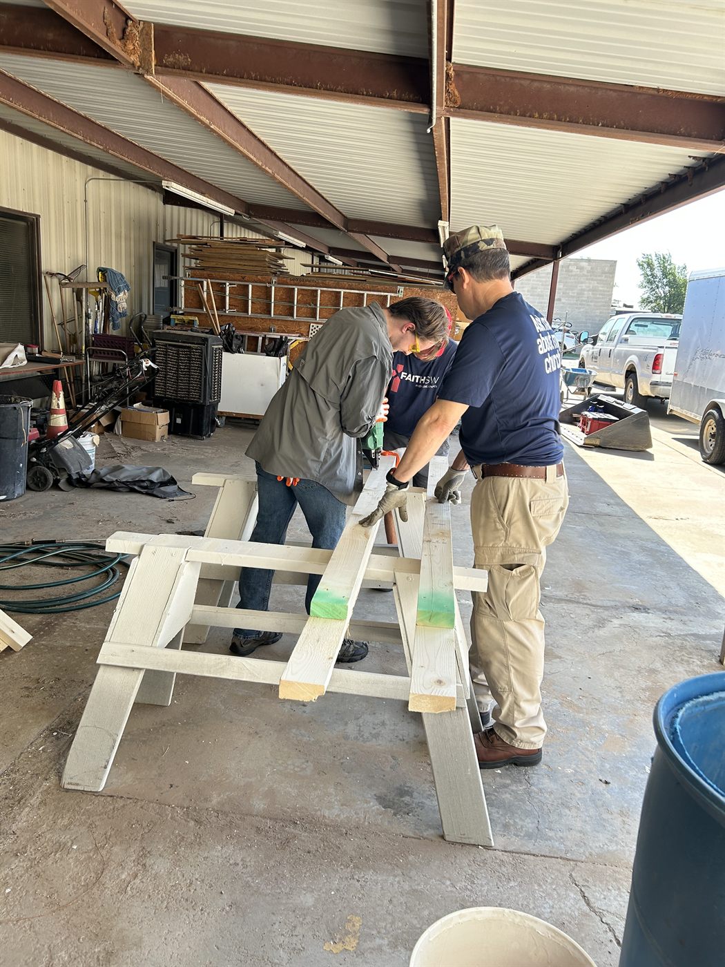 Faith SW volunteers drilling boards for a Habitat for Humanity project