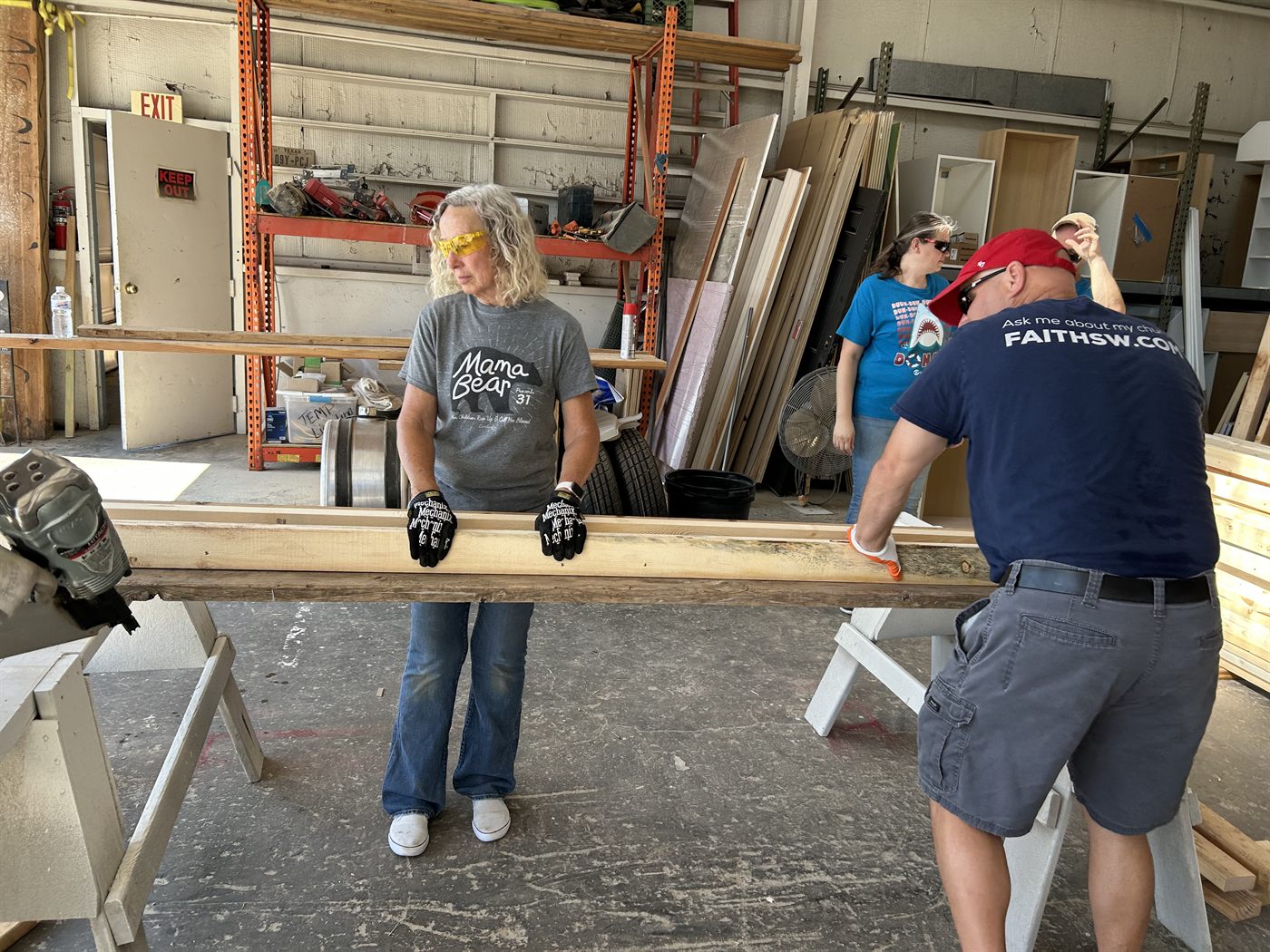 Faith SW volunteers moving lumber during the Habitat for Humanity work day
